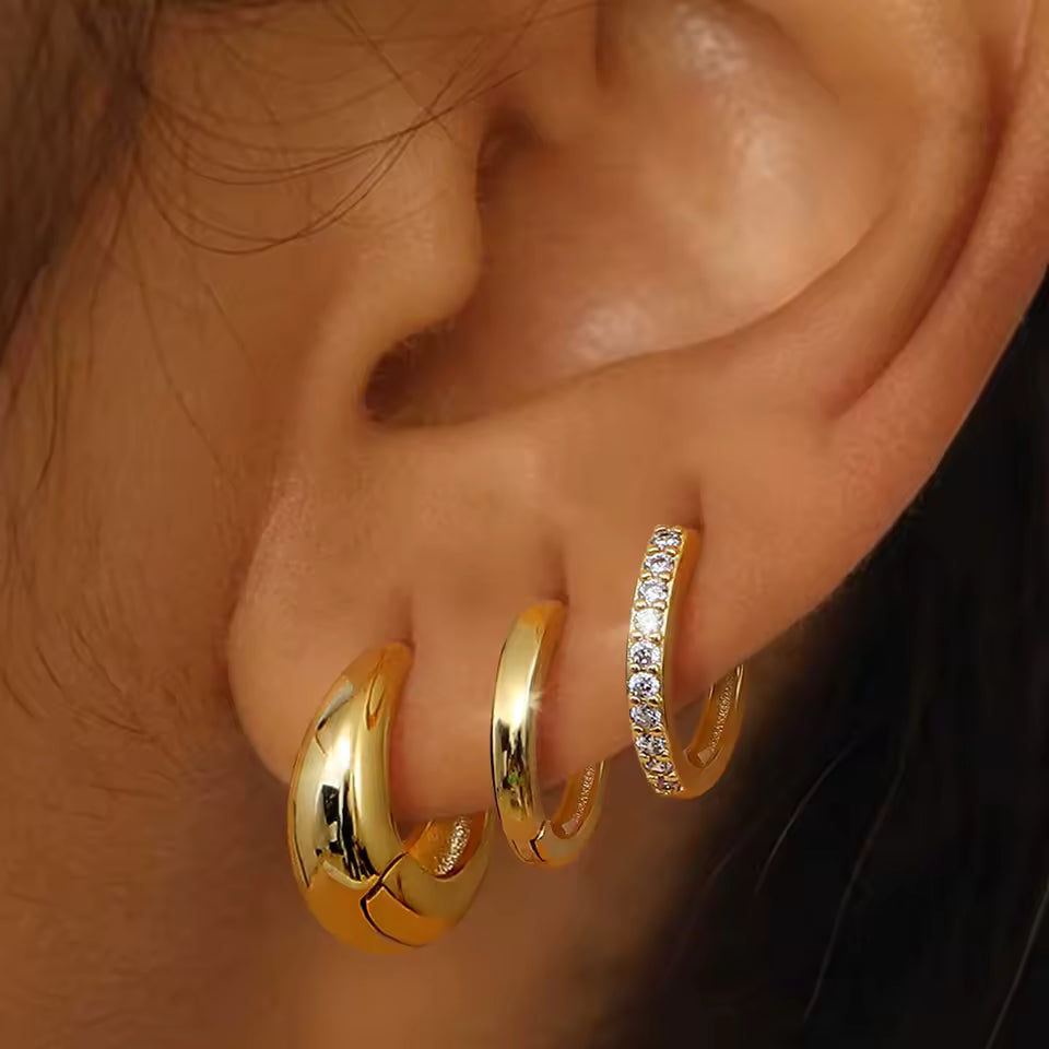 Close-up of the Lulu Set worn on the ear in gold, showing the teardrop, pave, and plain hoops stacked.