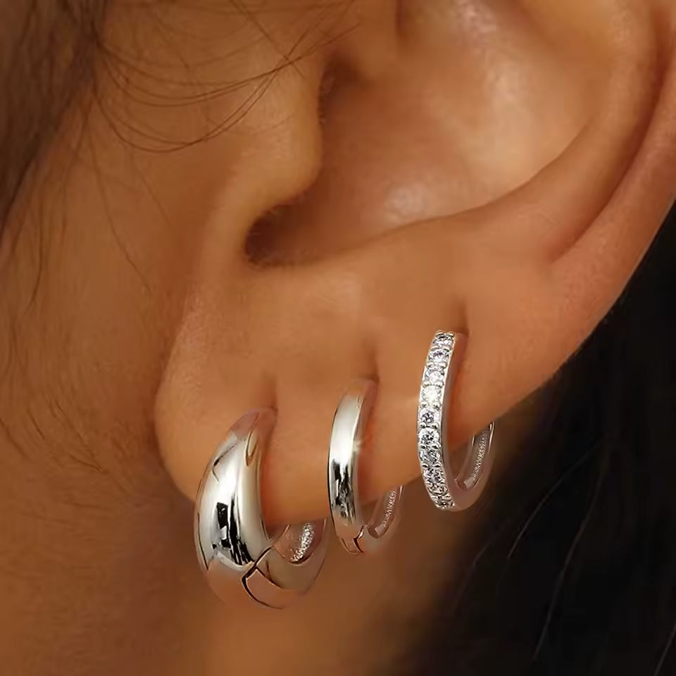 Close-up of the Lulu Set worn on the ear in silver tone, showing the teardrop, pave, and plain hoops stacked.