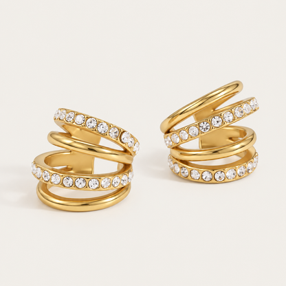 Pair of gold ear cuffs with a triple-row pavé crystal wrap, product shot for the Folie à Trois Lumen EAR CUFF.