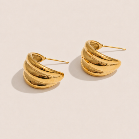Gold ridged half-hoop earrings with a chunky ribbed texture on a cream backdrop — Folie à Trois Lustro EARRINGS