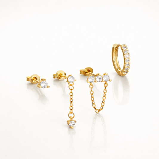 Maelys Set of gold jewelry, a crystal stud, a dangling chain stud, a front-back chain stud, and a pave hoop.