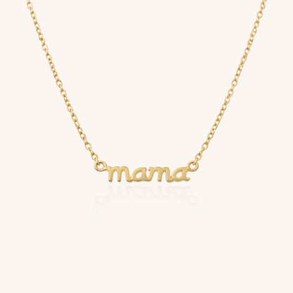 The Mama Small NECKLACE in gold, a delicate script mama pendant on a fine chain, shown flat on a cream background.