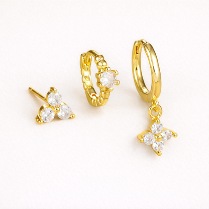 Manon Set of gold jewelry, a trio-stone stud, a beaded pave hoop, and a hoop with a dangling four-point crystal charm.
