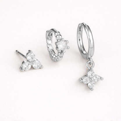 Manon Set in silver tone, a trio-stone stud, a beaded pave hoop, and a hoop with a dangling four-point crystal charm.