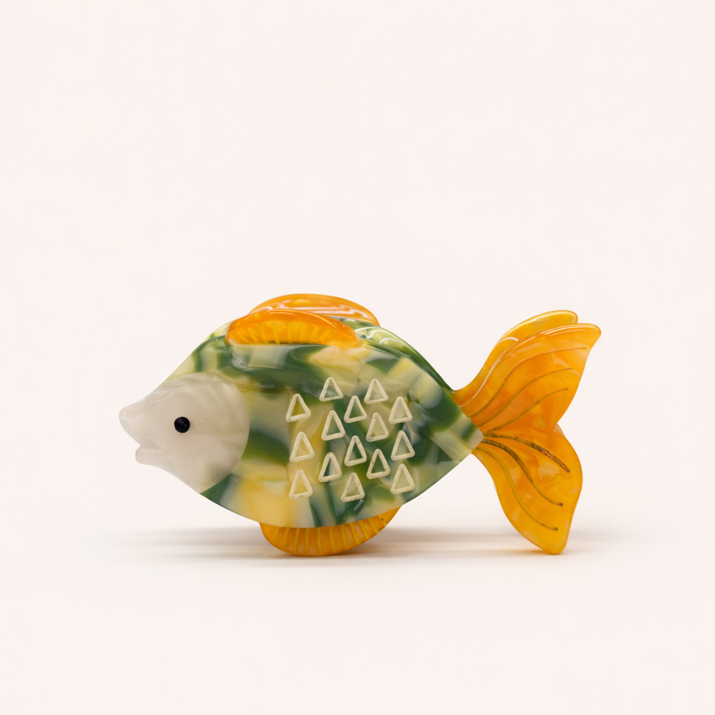 Marlin HAIR CLIP fish-shaped claw clip in a green and yellow marbled pattern with orange fins and white triangle scale details, studio shot.