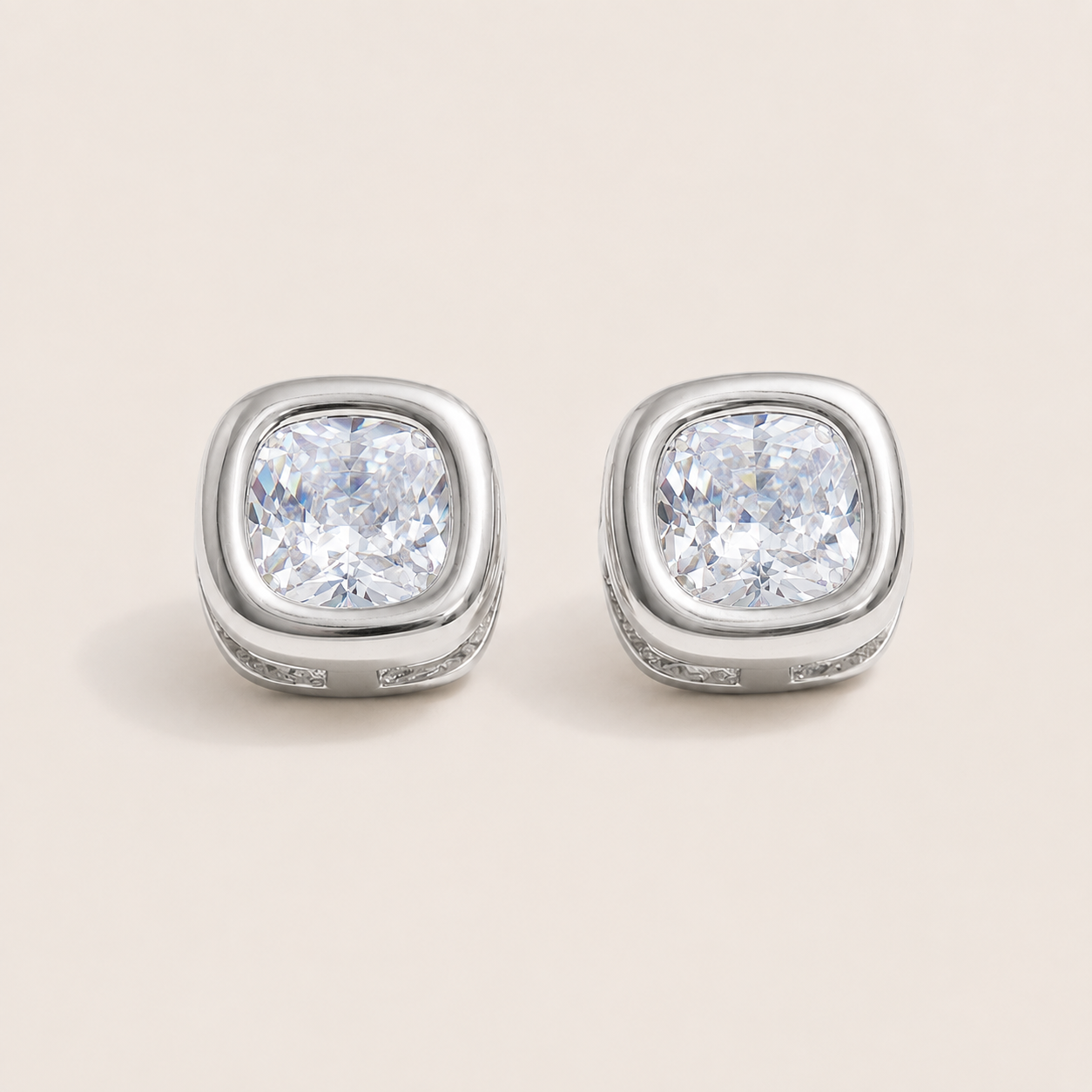 Silver stud earrings with a large cushion-cut white zirconia in a pavé bezel setting on a cream backdrop — Folie à Trois Meridian EARRINGS