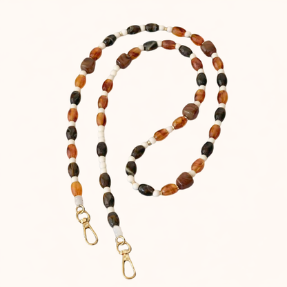 Brown and cream beaded Meryn long phone chain coiled flat with gold-tone clasp ends.