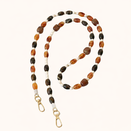 Brown and cream beaded Meryn long phone chain coiled flat with gold-tone clasp ends.