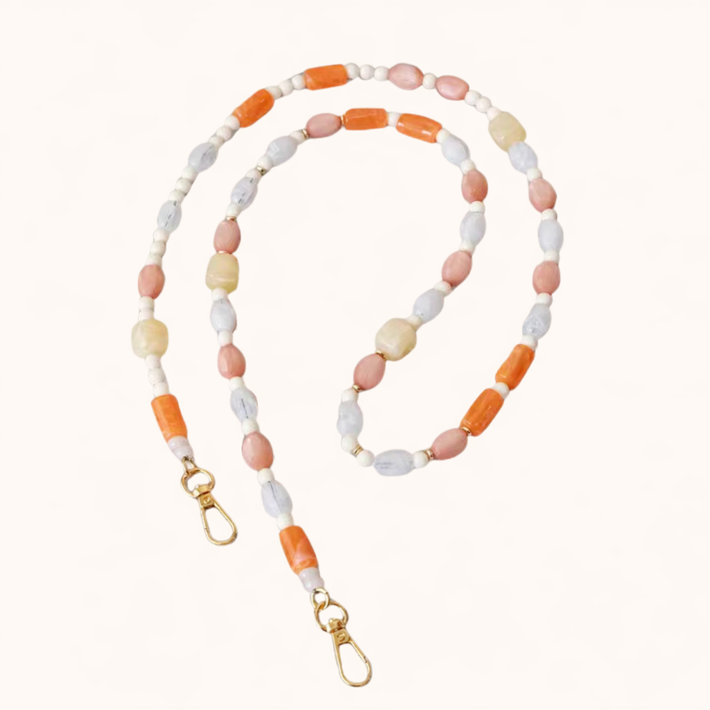 Pastel orange, pink, and lavender beaded Meryn long phone chain coiled flat with gold clasps.