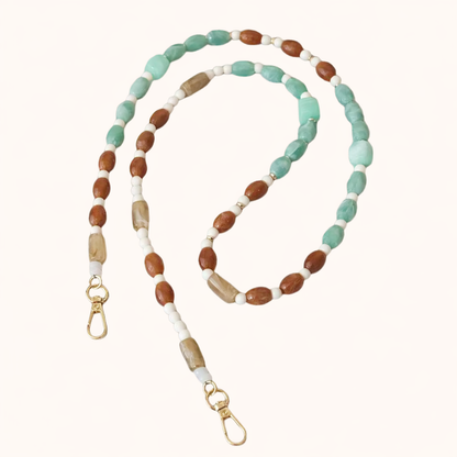 Green and brown beaded Meryn long phone chain coiled flat with gold-tone clasp ends.