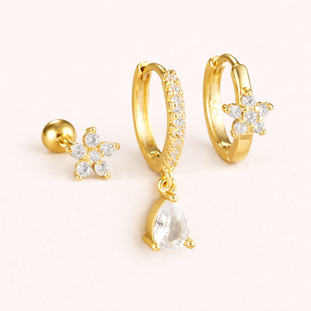 The Mica SET includes three gold pieces: a flower stud, a pave hoop with teardrop drop, and a flower huggie.