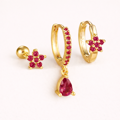 The Mica SET is shown in a pink crystal colorway across its flower stud, drop hoop, and flower huggie.