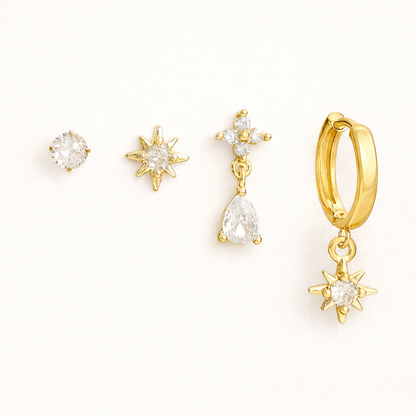 Mila Set of four gold pieces: a round solitaire stud, a star stud, a pear-crystal drop, and a star-charm huggie hoop.