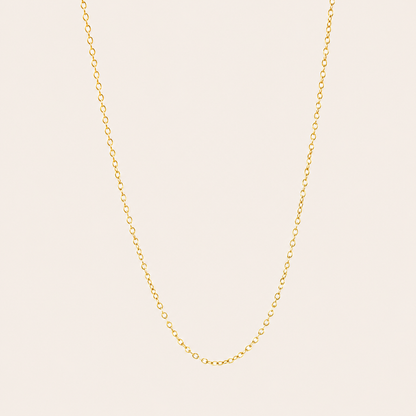 The Minimal NECKLACE in a flat lay, a fine gold cable chain shown plain with no charms on a cream background.