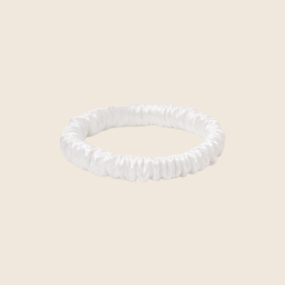 Minnie SCRUNCHIE S small satin scrunchie in rose pink, studio shot on a light beige background.