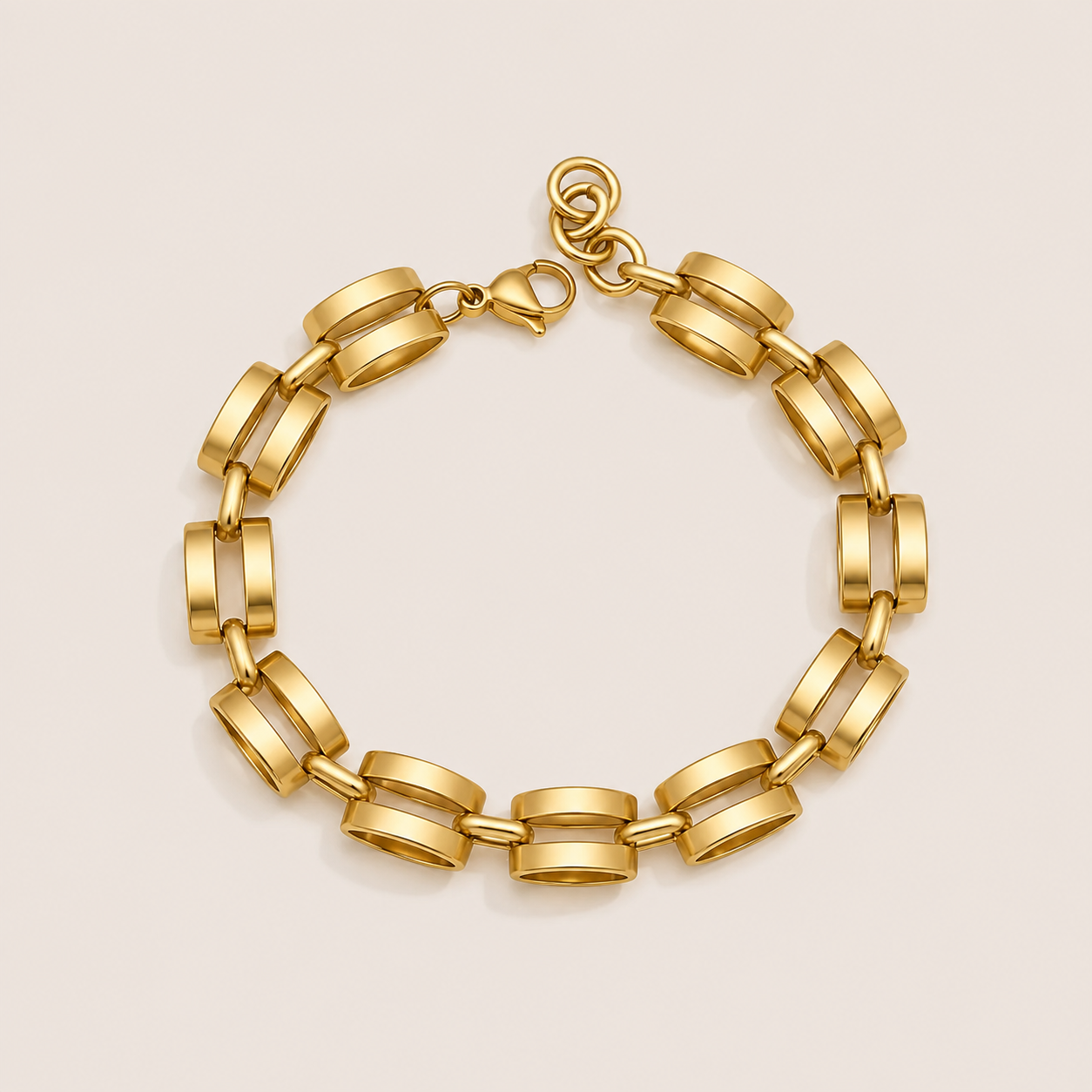 Mona BRACELET in gold with rectangular architectural links joined into a chain, shown flat on a soft beige background.
