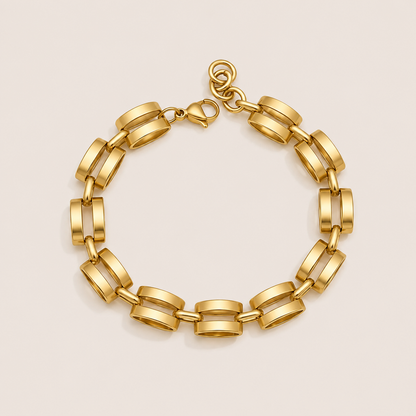 Mona BRACELET in gold with rectangular architectural links joined into a chain, shown flat on a soft beige background.