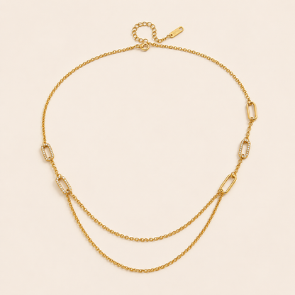 The Mora NECKLACE laid flat, showing pave crystal paperclip links alternating with plain cable chain and a draped double-chain section.