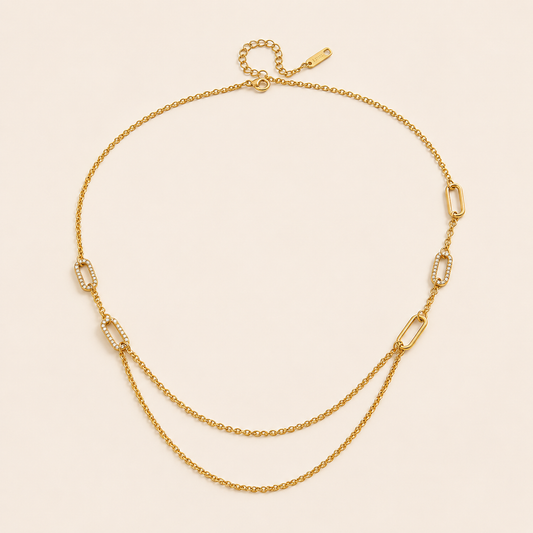 The Mora NECKLACE laid flat, showing pave crystal paperclip links alternating with plain cable chain and a draped double-chain section.