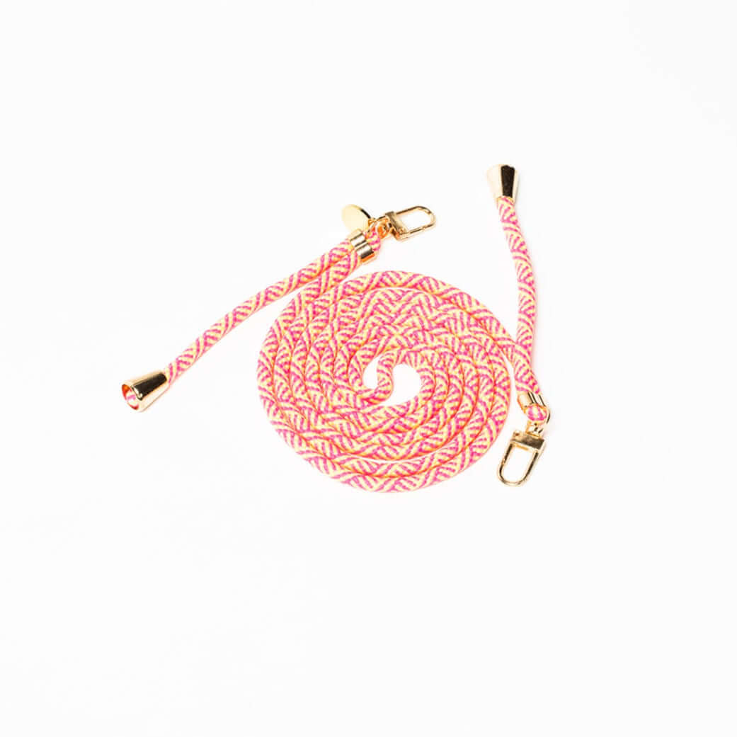 Pink, cream and yellow patterned Multi Colorful PHONE CORD coiled with gold-tone hardware on white.