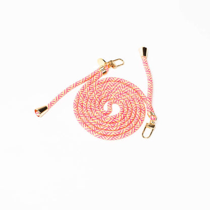 Pink, cream and yellow patterned Multi Colorful PHONE CORD coiled with gold-tone hardware on white.