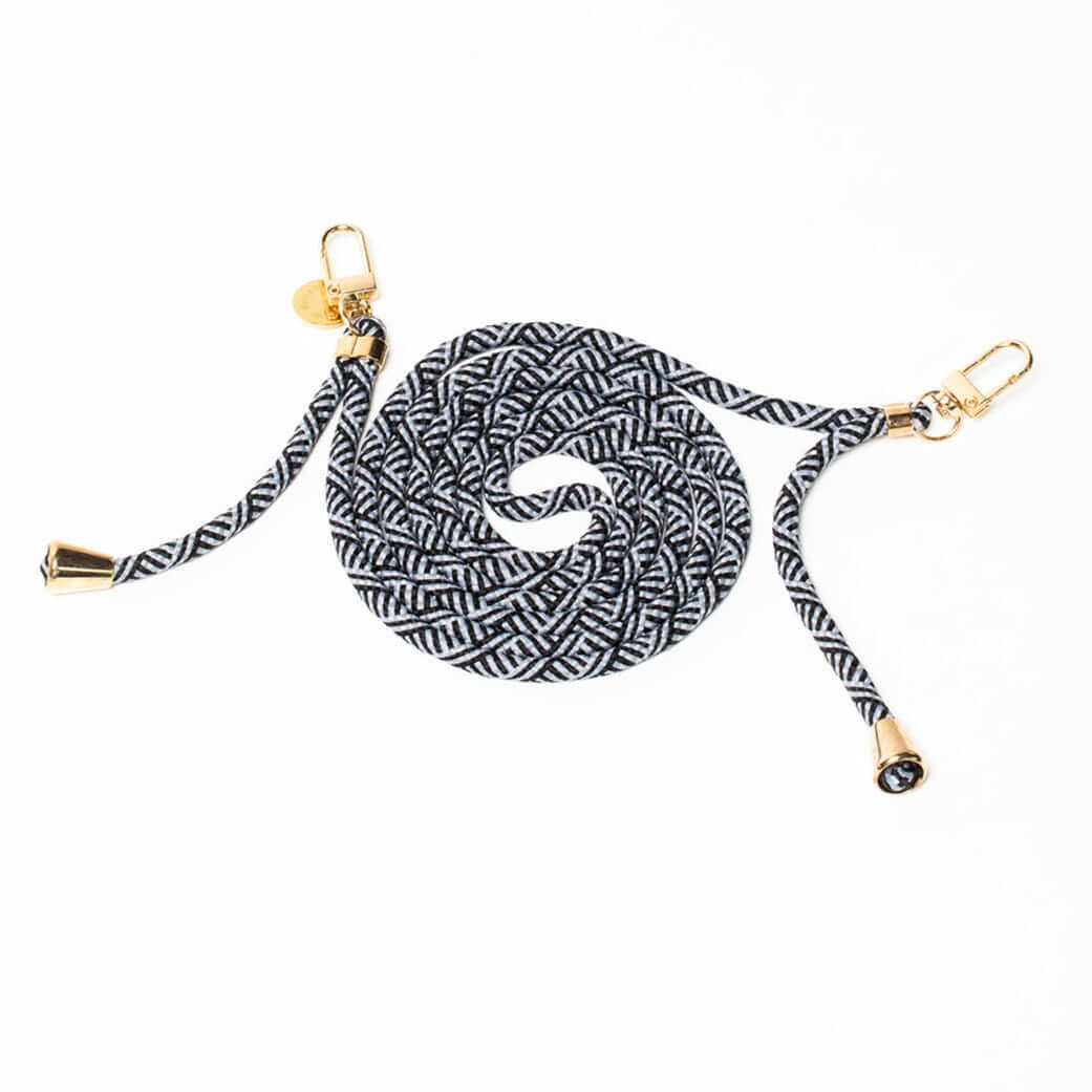 Black and white patterned Multi Colorful PHONE CORD coiled with gold-tone hardware on a white background.