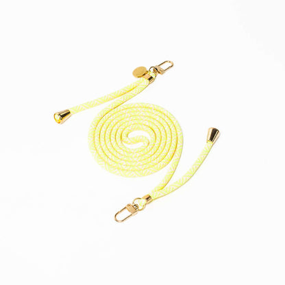 Pale yellow and white Multi Colorful PHONE CORD coiled with gold-tone hardware on a white background.