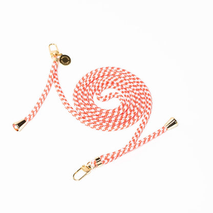 Coral and white patterned Multi Colorful PHONE CORD coiled with gold-tone hardware on a white background.