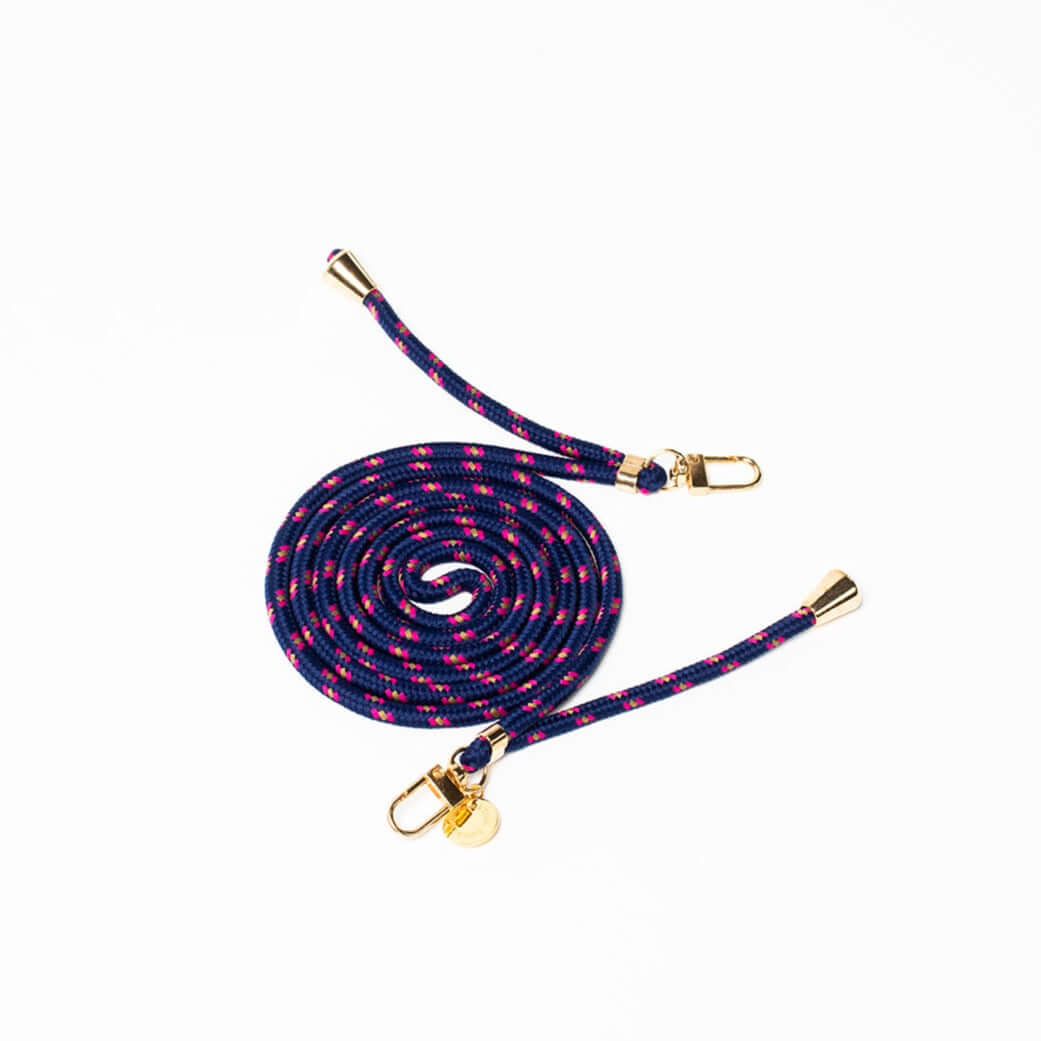 Navy, pink and white patterned Multi Colorful PHONE CORD coiled with gold-tone hardware on white.