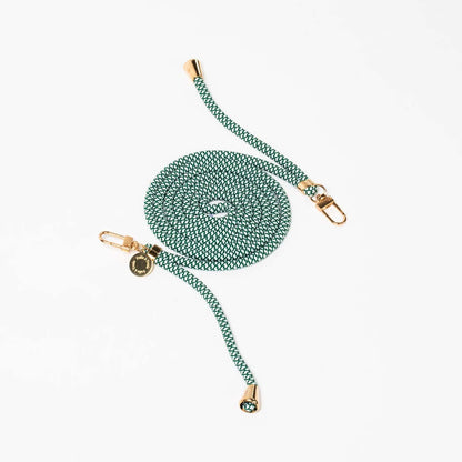 Green and white patterned Multi Colorful PHONE CORD coiled with gold-tone hardware on a white background.