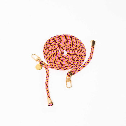 Pink, orange and burgundy patterned Multi Colorful PHONE CORD coiled with gold-tone hardware on white.