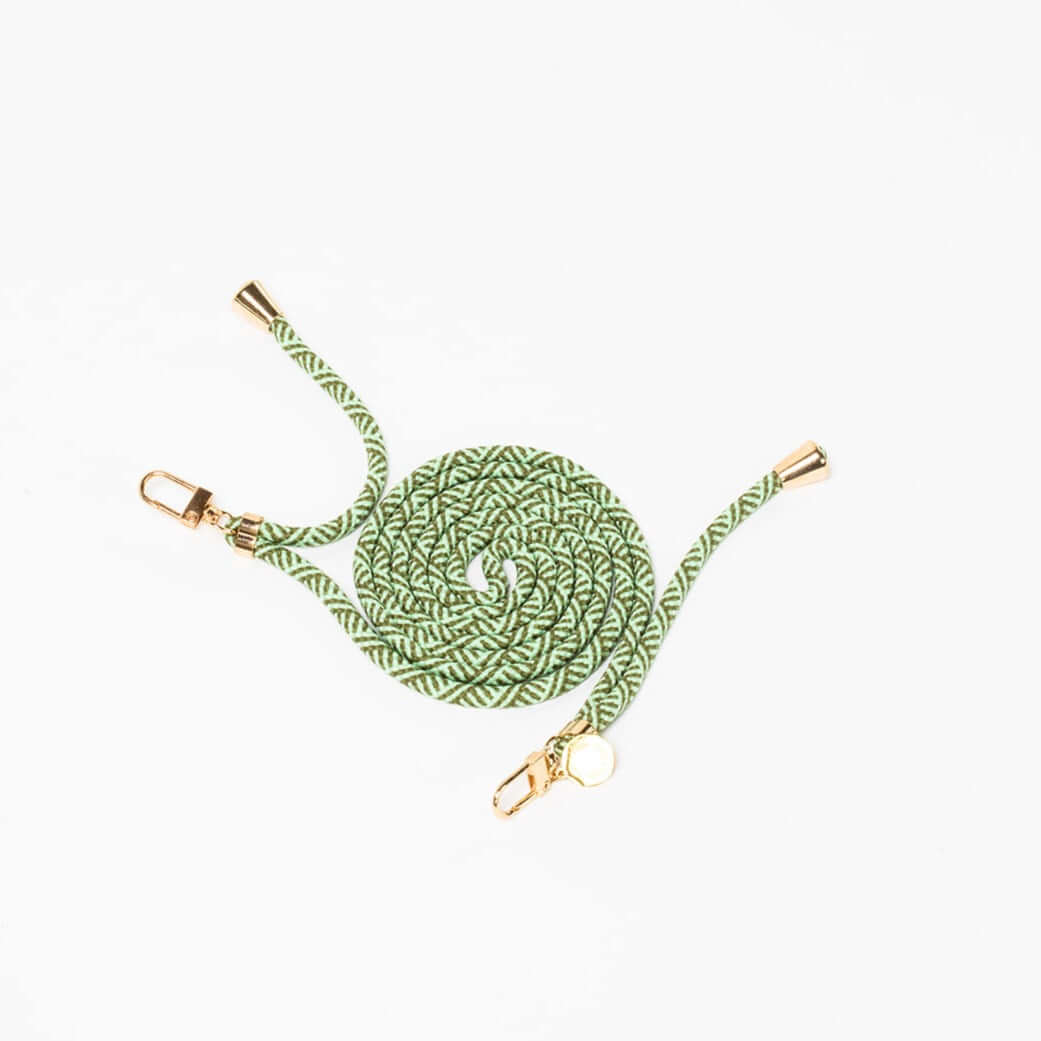 Sage green and white patterned Multi Colorful PHONE CORD coiled with gold-tone hardware on white.