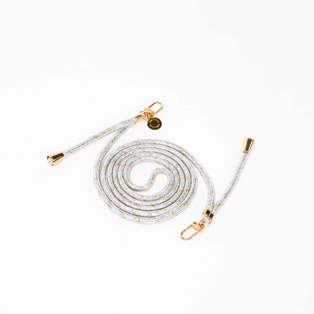 Silver and gold metallic patterned Multi Colorful PHONE CORD coiled with gold-tone hardware on white.