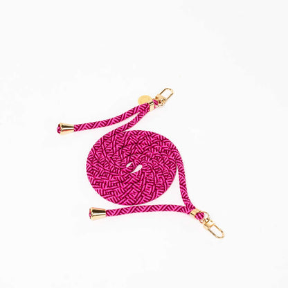 Magenta and burgundy patterned Multi Colorful PHONE CORD coiled with gold-tone hardware on a white background.