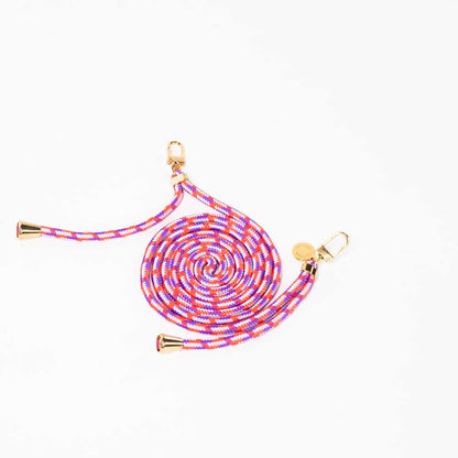 Coral, purple and white patterned Multi Colorful PHONE CORD coiled with gold-tone hardware on white.