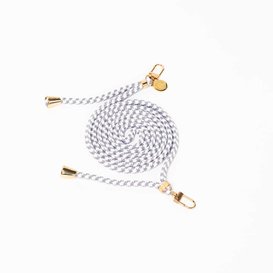 Gray and white patterned Multi Colorful PHONE CORD coiled with gold-tone hardware on a white background.