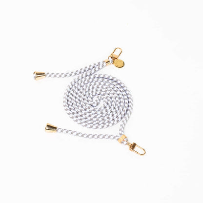 Gray and white patterned Multi Colorful PHONE CORD coiled with gold-tone hardware on a white background.