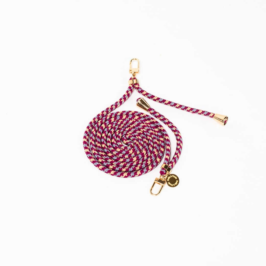 Burgundy, gray and cream patterned Multi Colorful PHONE CORD coiled with gold-tone hardware on white.