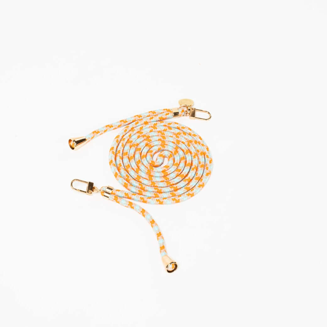 Mint and orange patterned Multi Colorful PHONE CORD coiled with gold-tone hardware on a white background.
