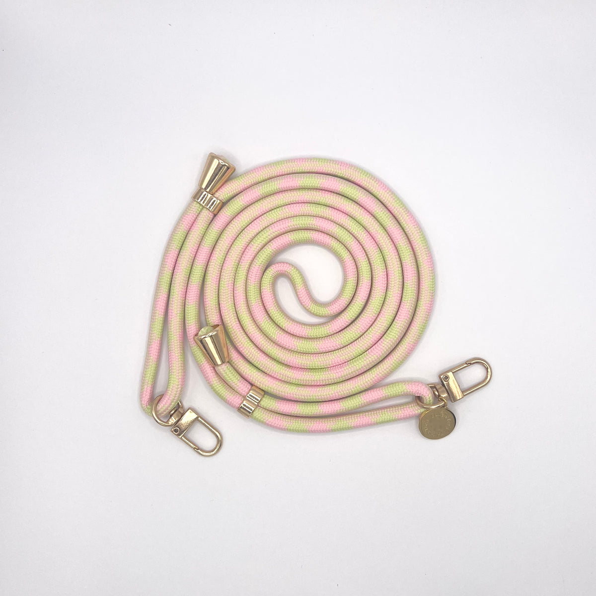 Pink and green pastel patterned Multi Colorful PHONE CORD coiled with gold-tone hardware on a white background.