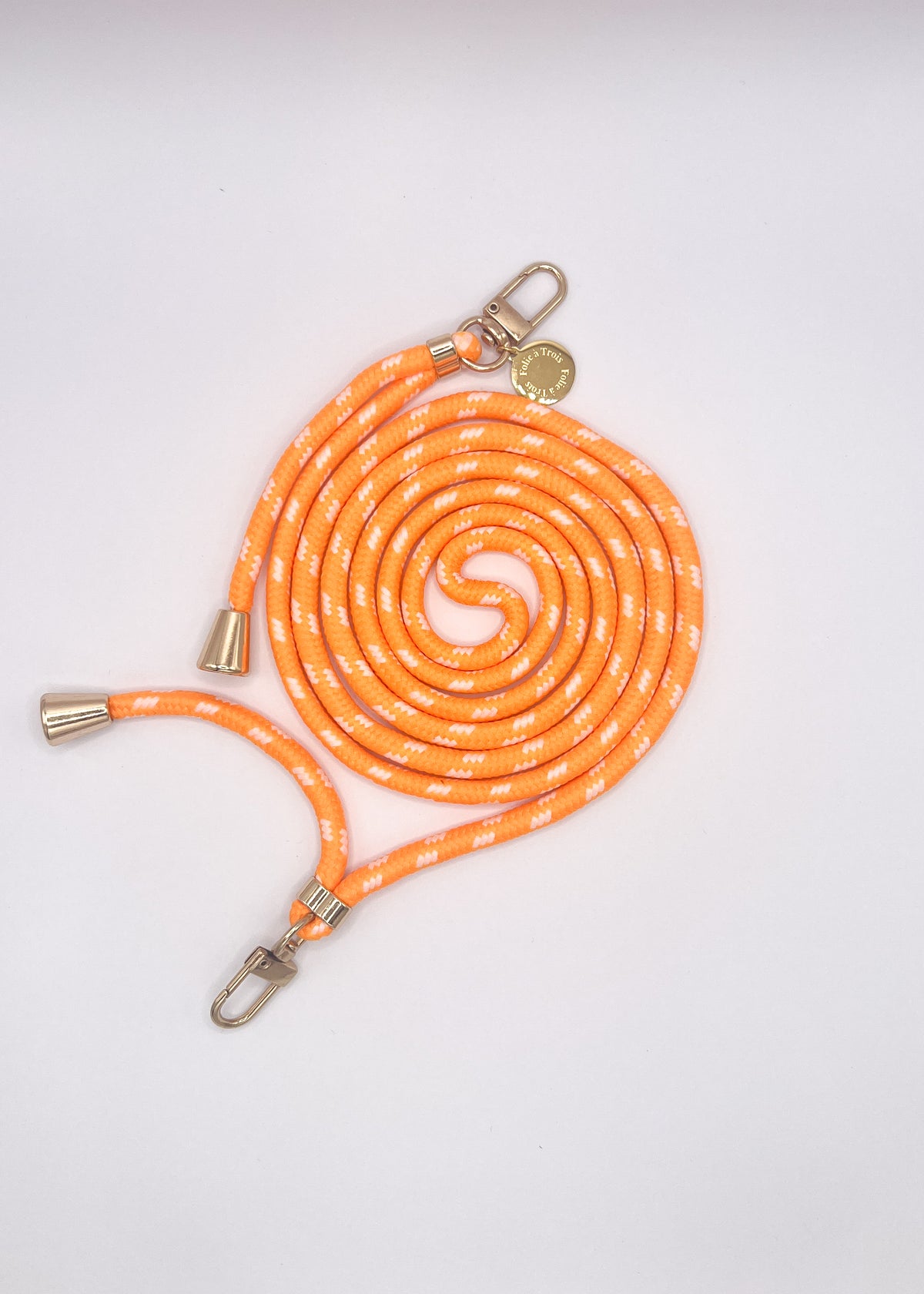 Orange and white patterned Multi Colorful PHONE CORD coiled with silver-tone hardware on a white background.