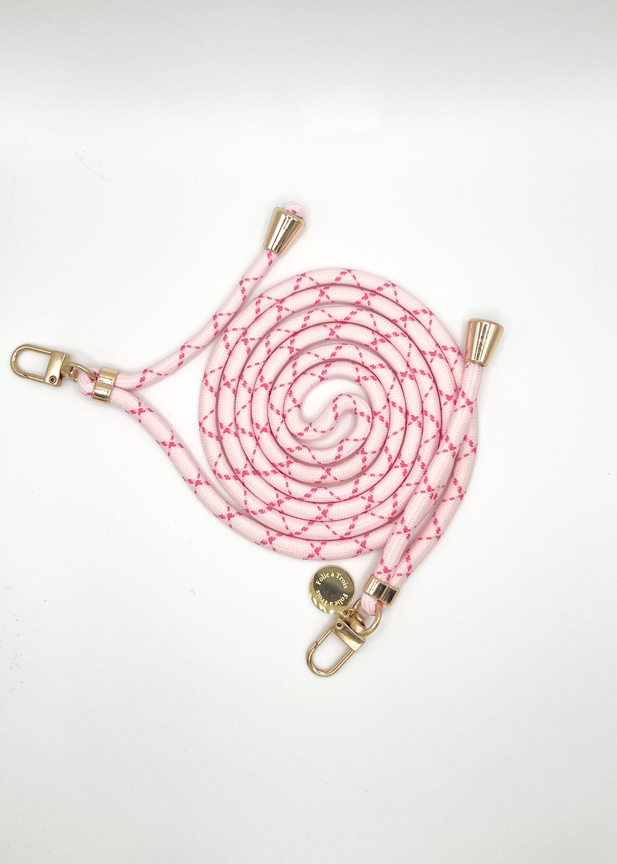 Pale pink and magenta patterned Multi Colorful PHONE CORD coiled with gold-tone hardware on white.