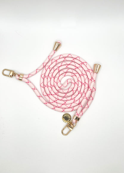 Pale pink and magenta patterned Multi Colorful PHONE CORD coiled with gold-tone hardware on white.