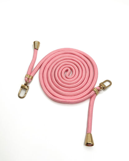 Pink and white patterned Multi Colorful PHONE CORD coiled with gold-tone hardware on a white background.