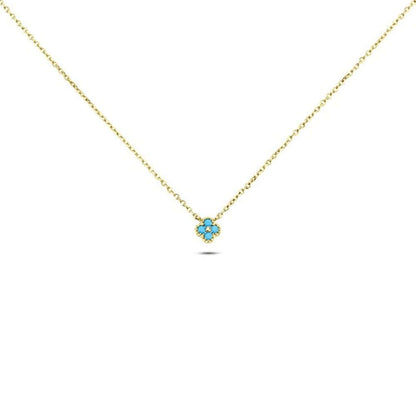 The Nessa NECKLACE in gold with turquoise stones, a small clover-shaped cluster pendant on a fine chain, shown flat.