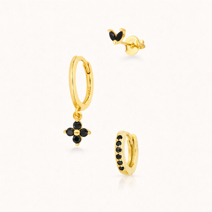 The New Perspective SET in gold with black onyx stones, showing the marquise stud, flower dangle hoop, and pavé hoop together in studio.