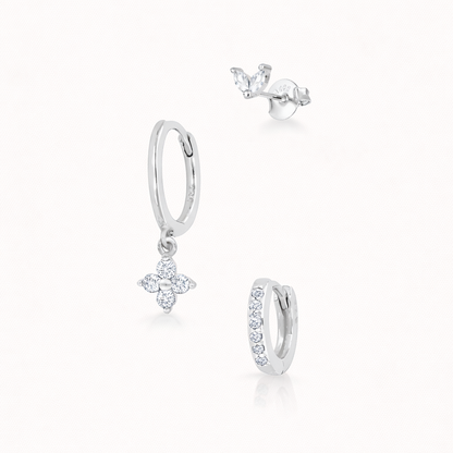The New Perspective SET in silver with clear crystal stones, showing the marquise stud, flower dangle hoop, and pavé hoop in studio.