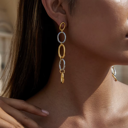 Worn along the ear, the No Apologies EARRINGS cascade in soft light with their alternating oval links.