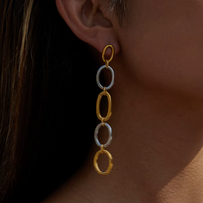 In close-up profile, the No Apologies EARRINGS show their five-link chain glinting against sunlit skin.