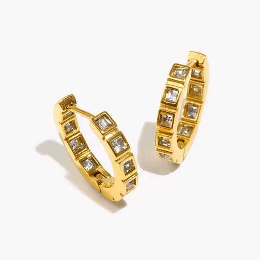 No Filter Earrings in gold, huggie hoops set with square-cut crystals in bezel settings, shown as a pair.